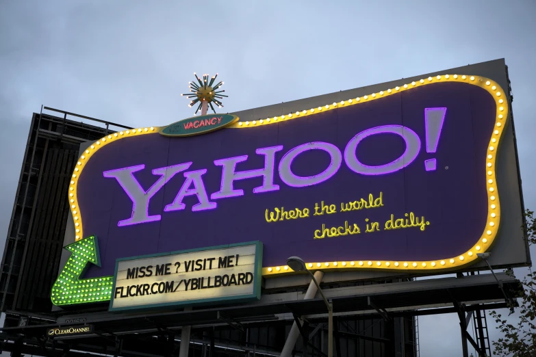 a yahoo neon sign is lit up with the word yahoo