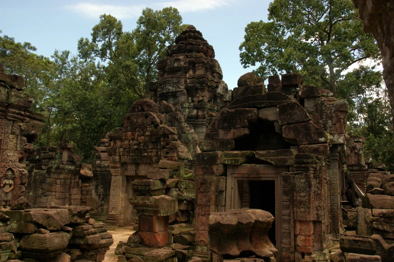 a group of stone buildings surrounded by trees