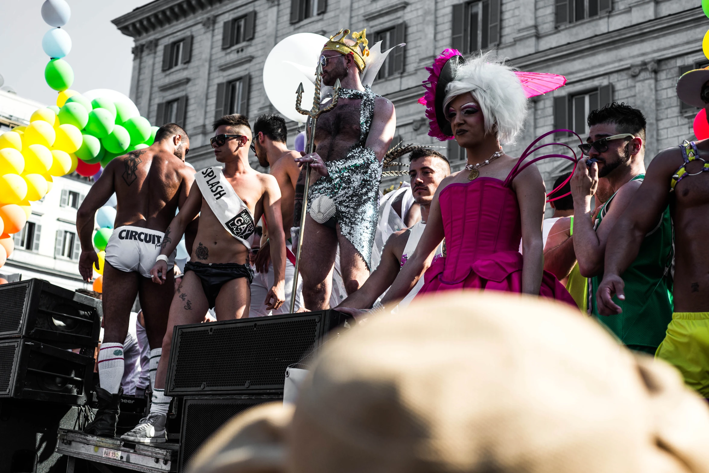 several men and women dressed in costumes are standing on the back of a truck