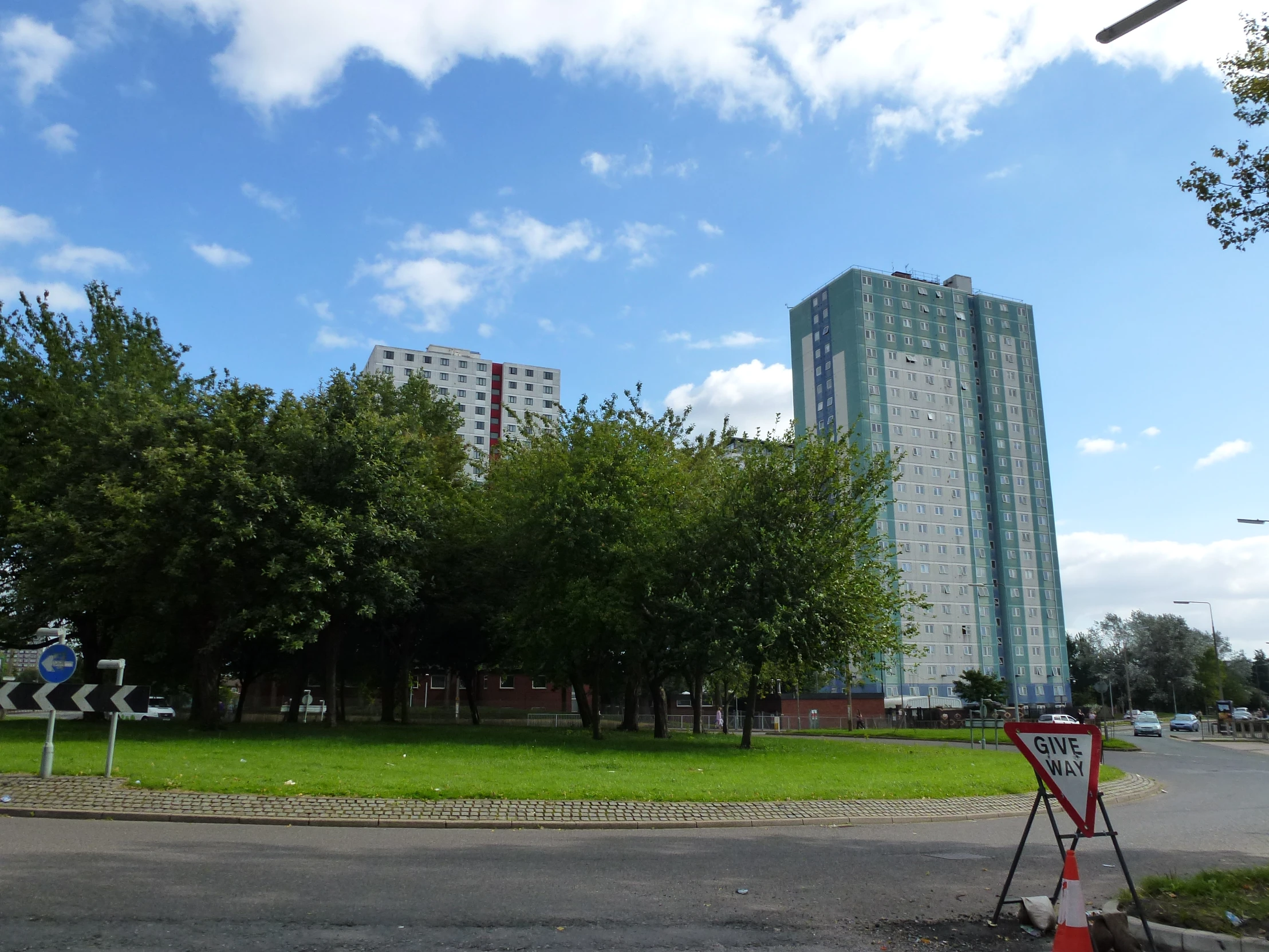 an empty parking lot in front of some tall buildings