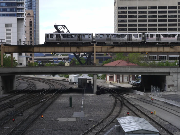 train on elevated track next to urban buildings