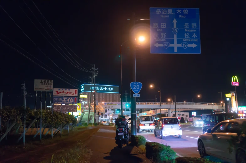 some traffic going down a city street at night