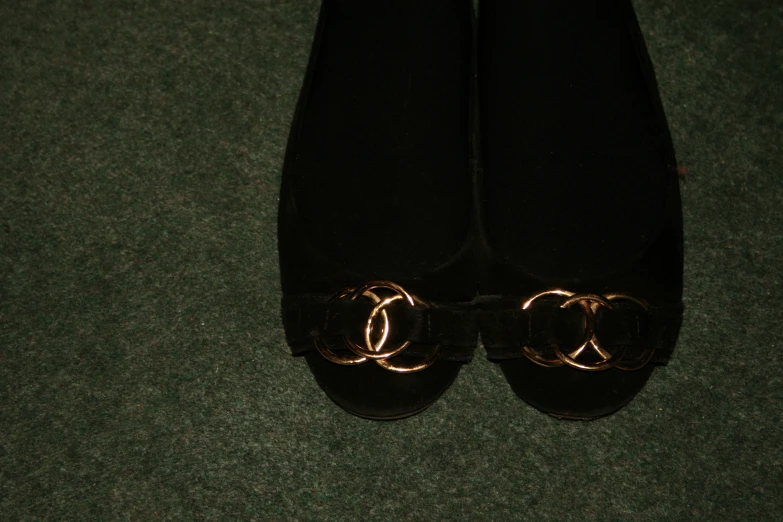 the black shoes are being displayed on the carpet