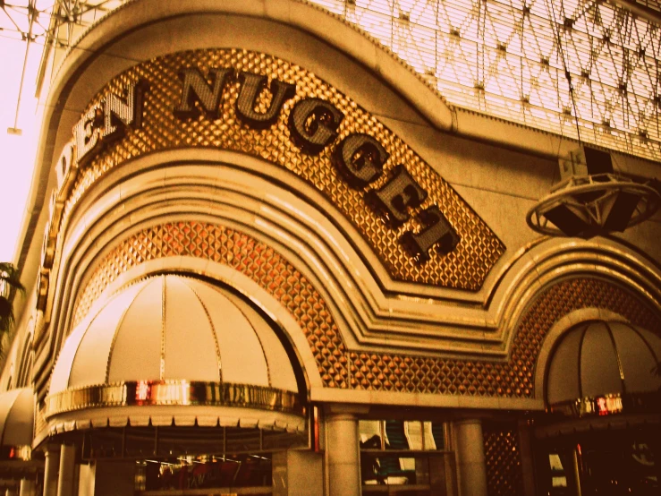 a large building with a huge gold sign above it