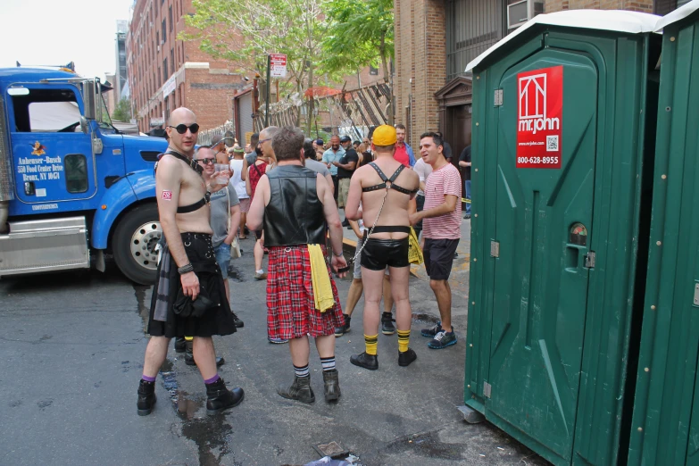 a group of men standing outside wearing underwear