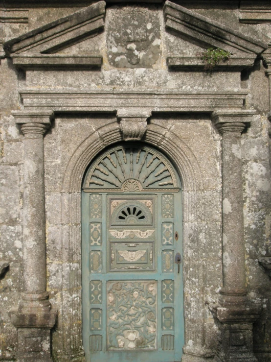 a stone building with a door that has carvings on it