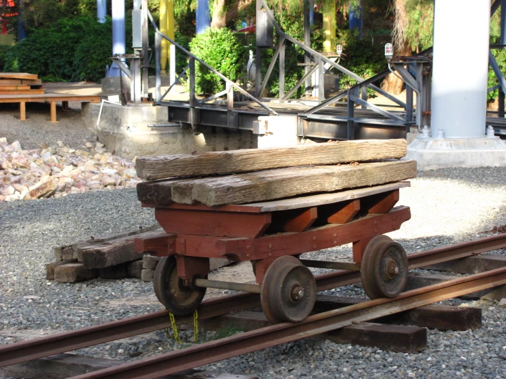 an old wooden wagon is parked on the rails