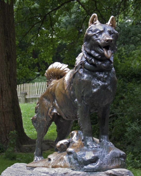 a statue of a dog on a rock