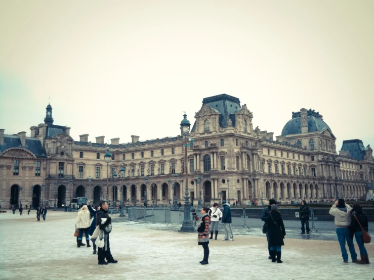 people standing in front of a building on the ground