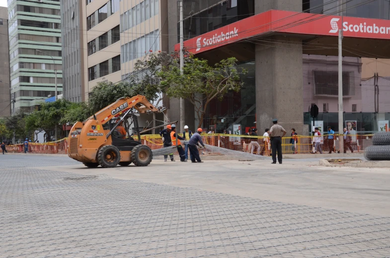 an orange crane in front of some tall buildings