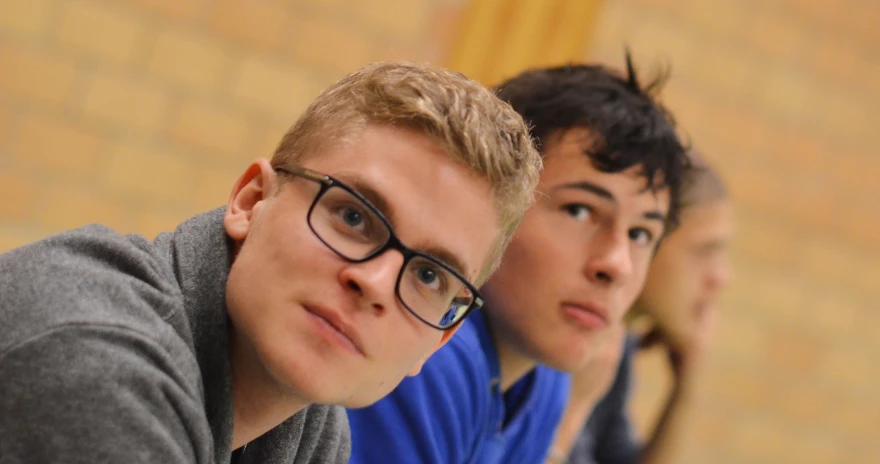 a group of young men sitting next to each other