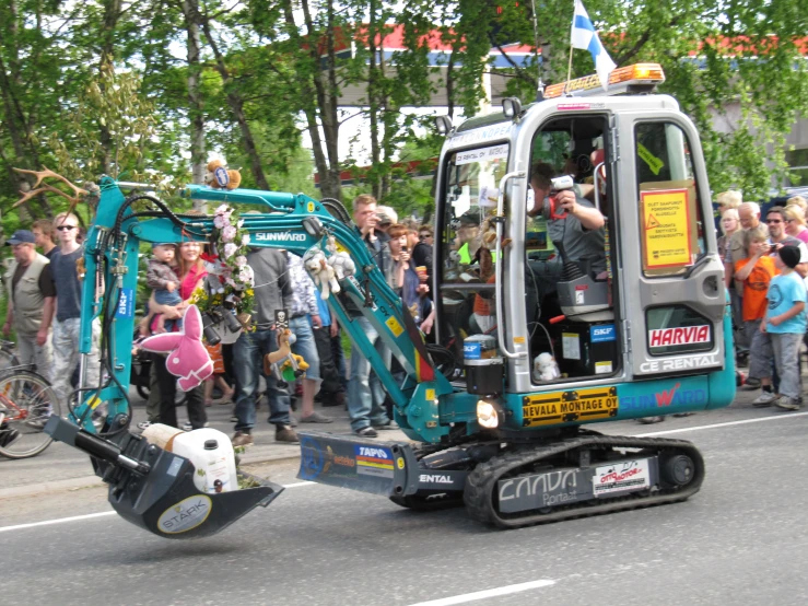 a large wheel vehicle in front of a crowd