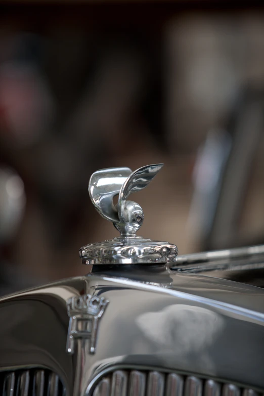 a vintage car has a emblem on the hood