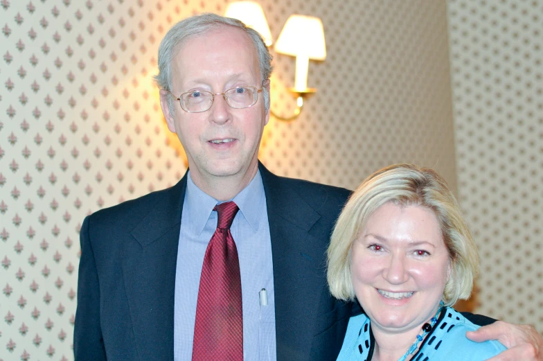 a man and a woman standing in front of a wall