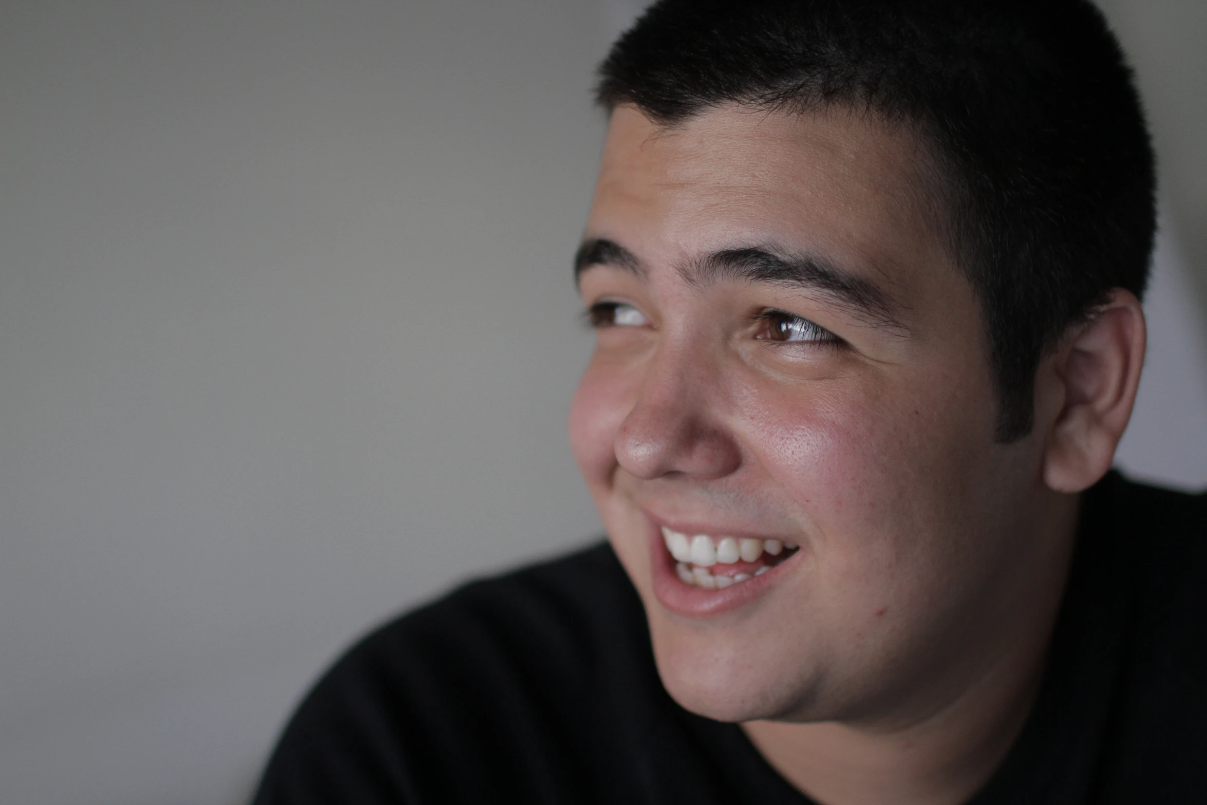 a man who is smiling with a toothbrush in his mouth