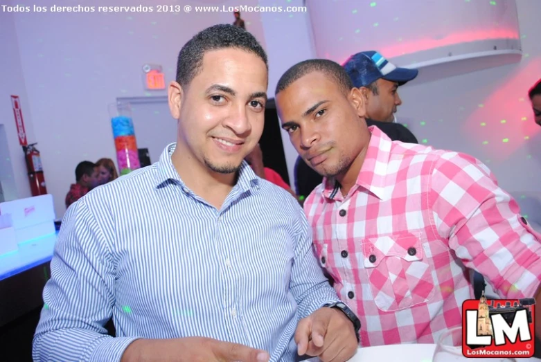 two men sitting at table at a party