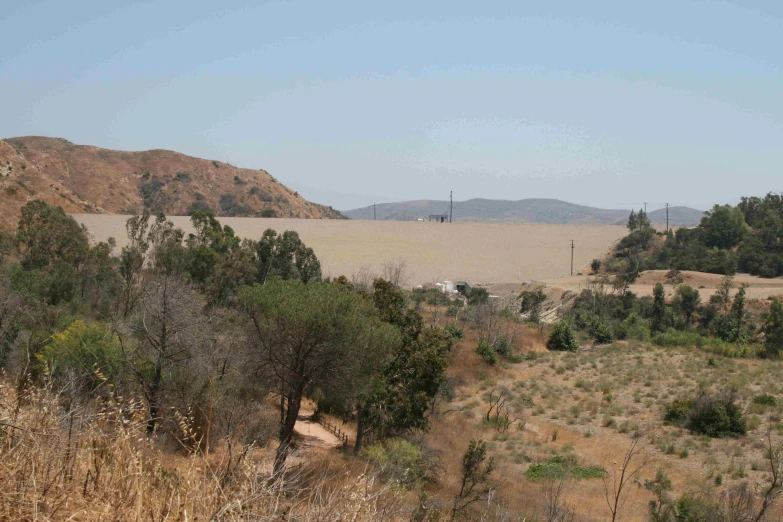 a po taken from the top of a hill with mountains in the distance