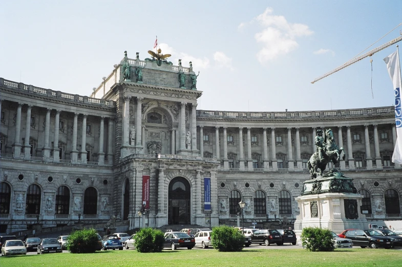 the building has statues on display and landscaping around it