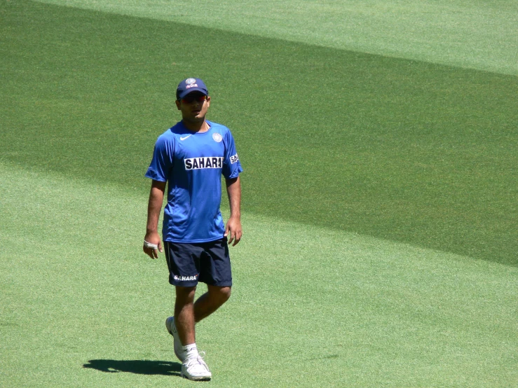 a man in blue and white on green grass