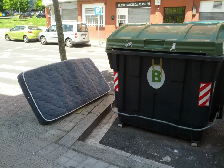 two dumpsters sitting outside next to each other