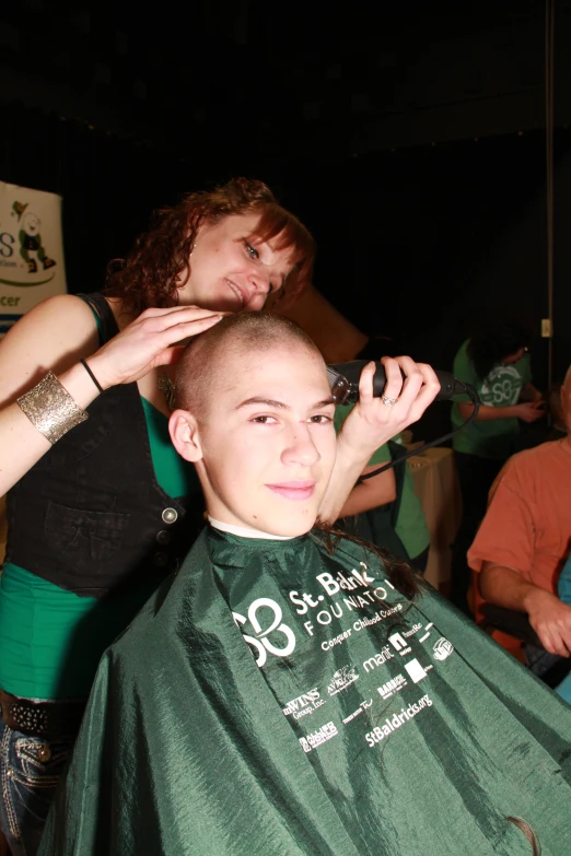 a woman is getting her hair cut and ready for some action
