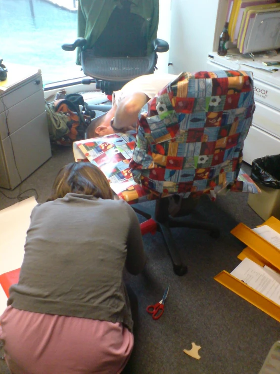 a person sitting on a chair with a piece of furniture