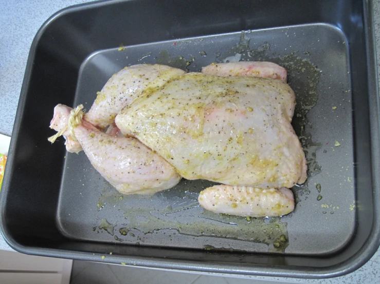 a close up of a chicken on a pan
