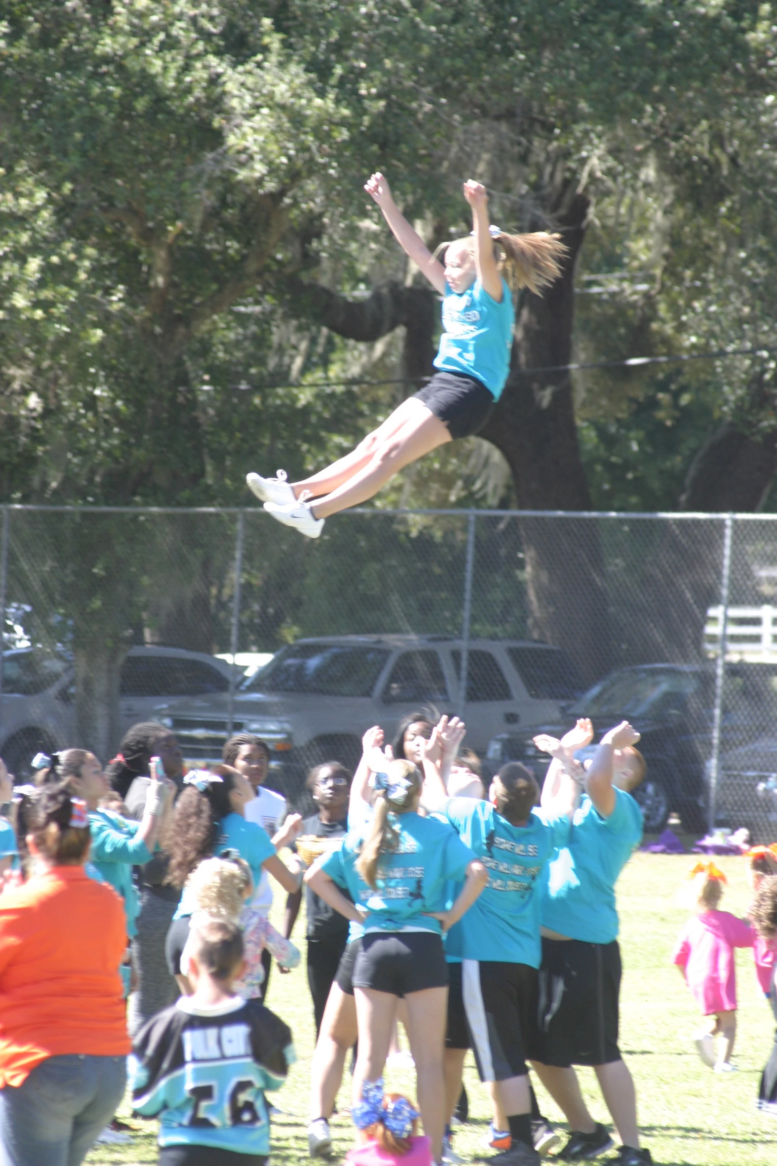 a woman flying through the air while riding a skateboard