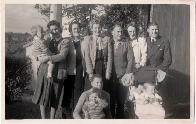 a group of people holding baby in a stroller