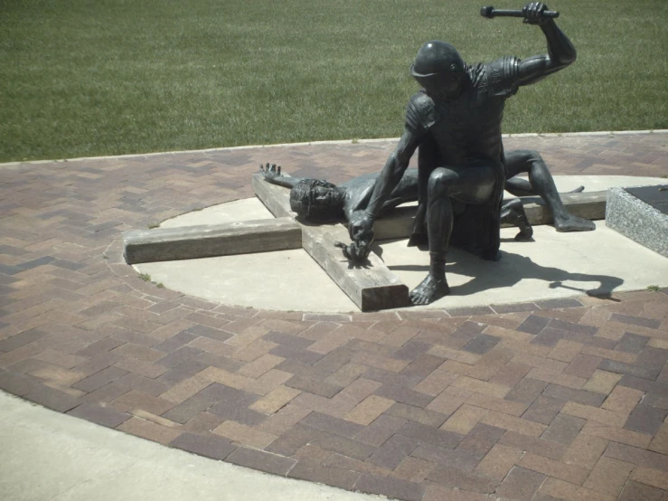 there is a bronze statue of a person holding a bat