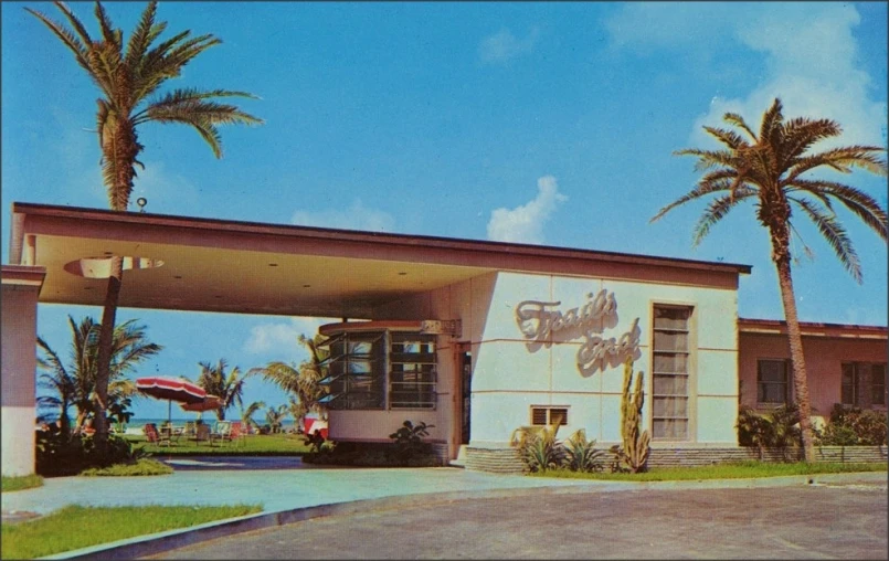 an old picture of a gas station with palm trees