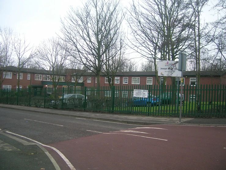 a street that has a fence next to it