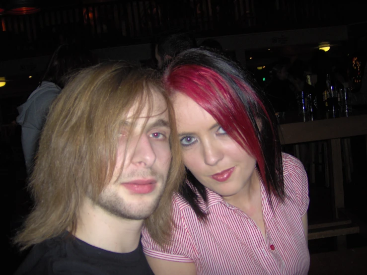 young man standing next to his lady at a party