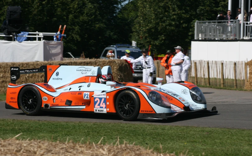 a car in motion with other cars and people behind