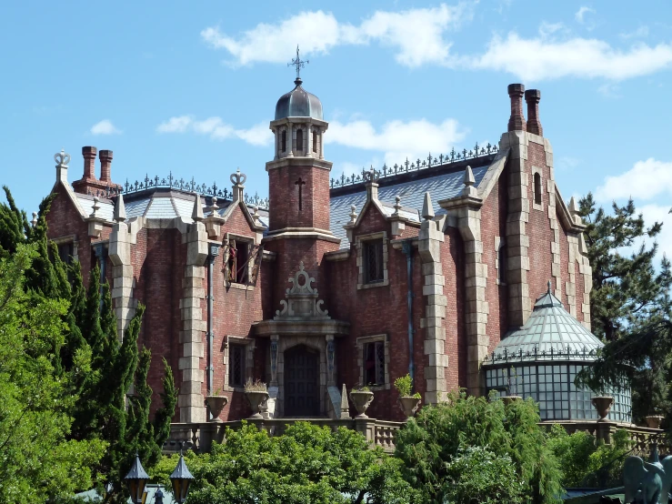 a very old red brick building with many chimneys