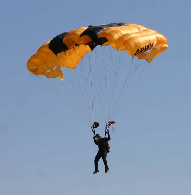 a person riding on top of a parachute over the sky