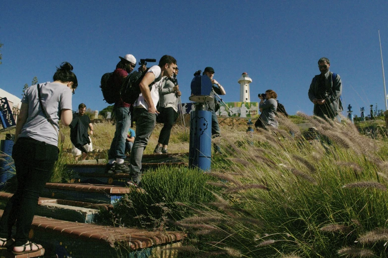 people walking down the stairs to a lighthouse