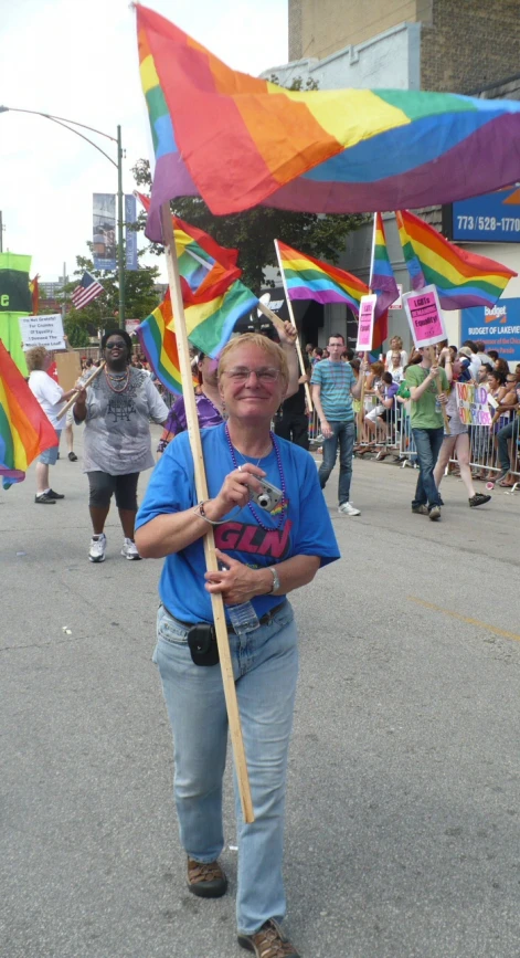a person holding a pride flag in the street