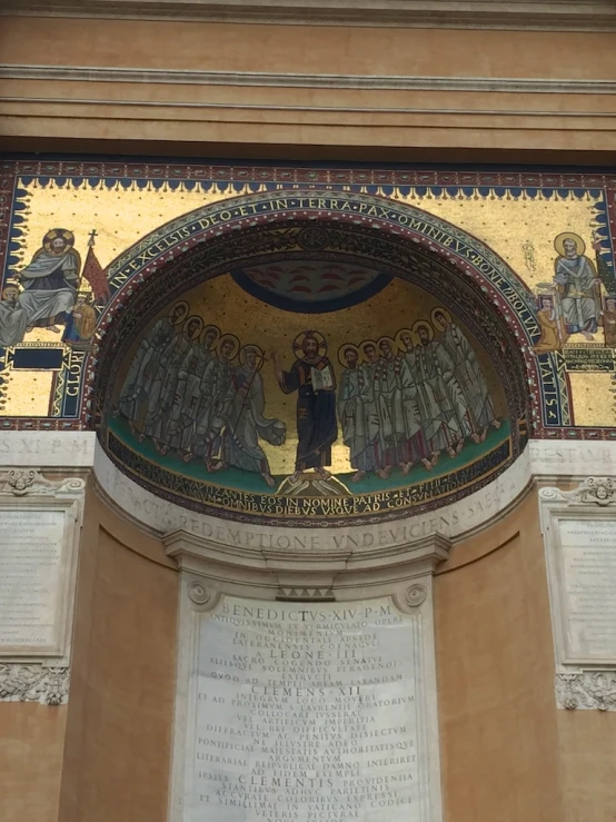 an archway over a wall has an elaborate painting