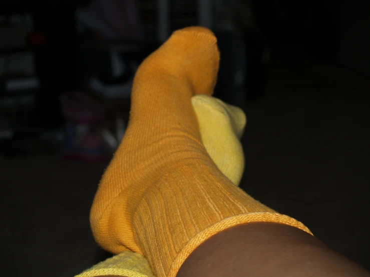 a pair of socks on the left and right feet, sitting in a persons feet