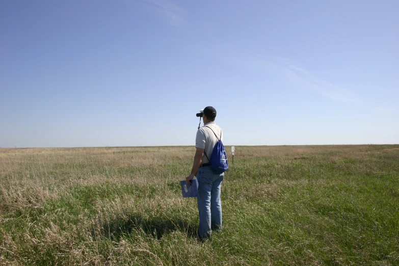 a person standing in a field looking into the distance