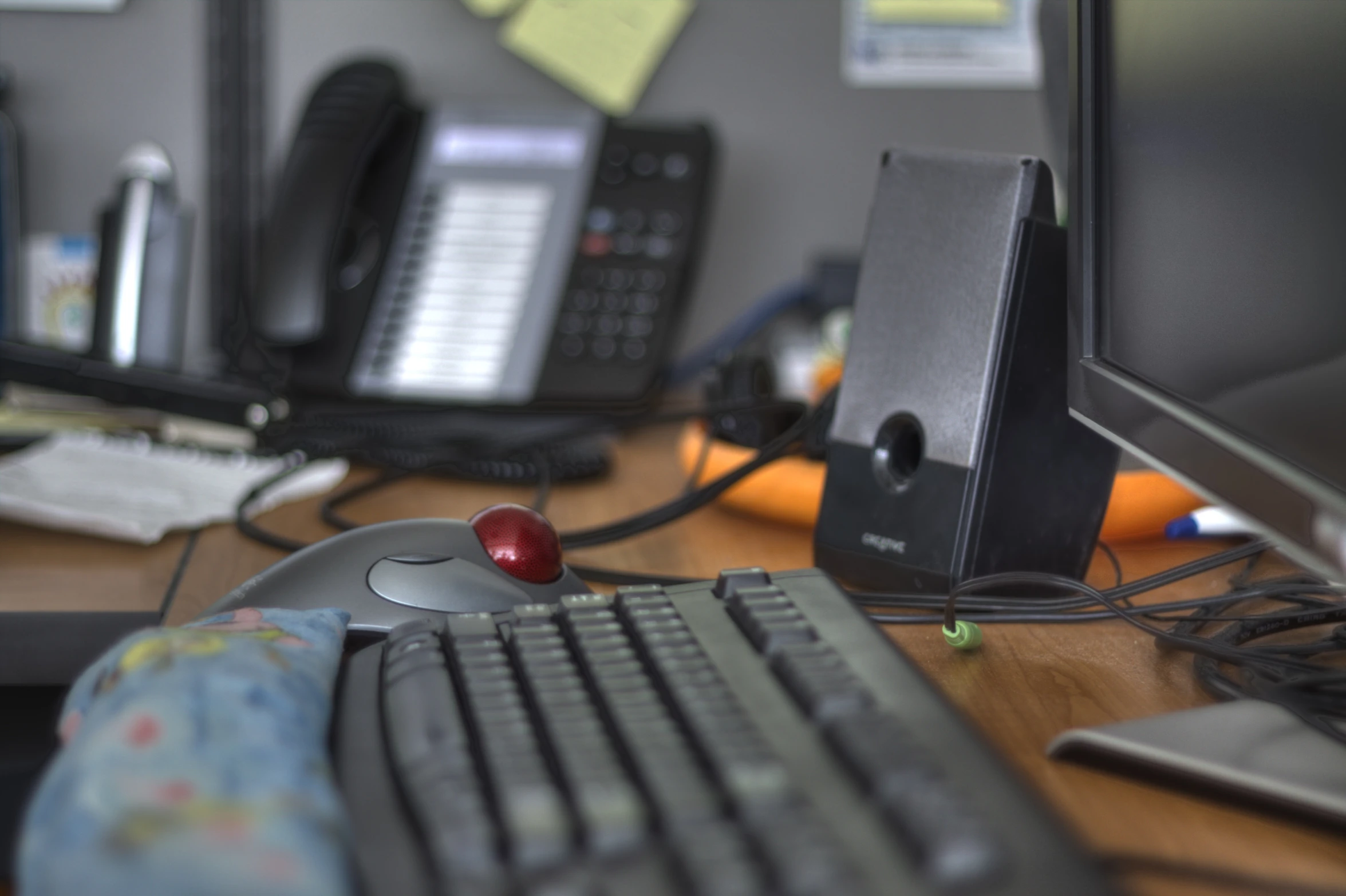 a desktop with telephones and other electronics on it