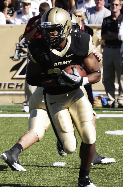 a football player runs with the ball during a game