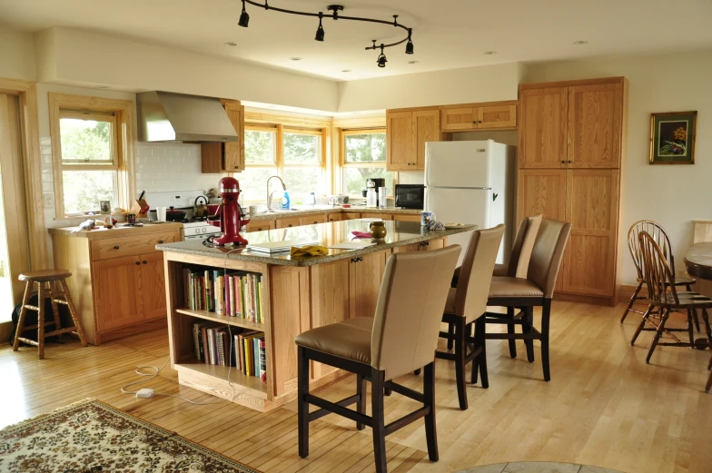 the kitchen island has several chairs in it