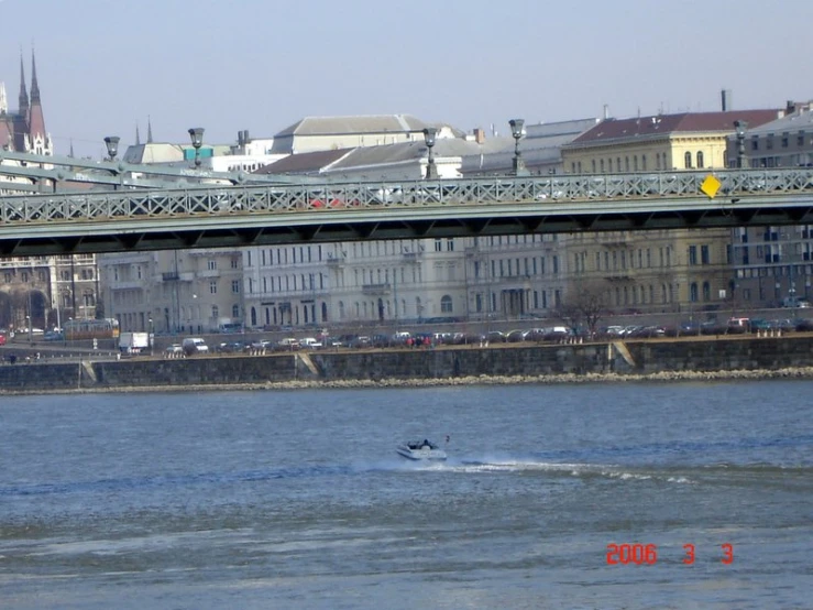 a small boat sailing past tall buildings in the city