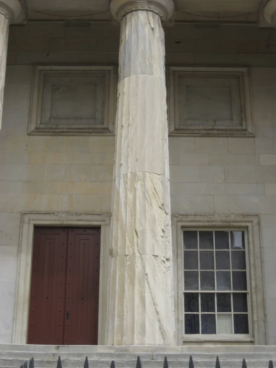 the two white pillars of the building with windows