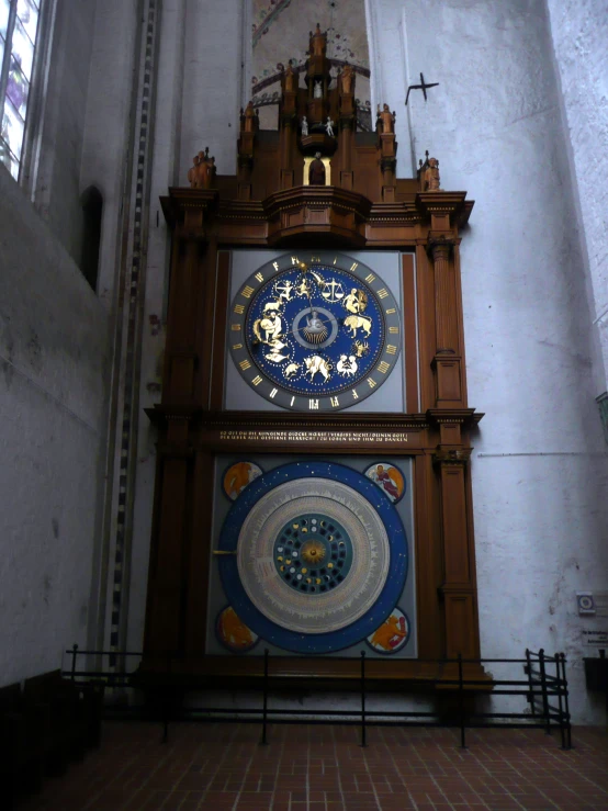 an elaborate wooden clock hanging in the center of a room