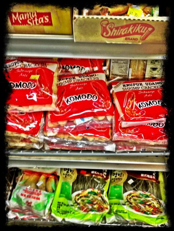 an open freezer door showing assorted sandwiches and chips