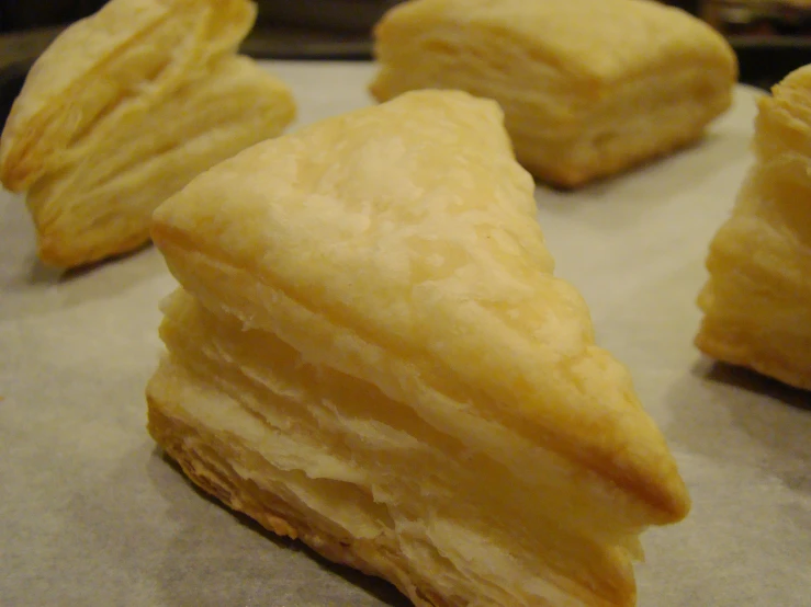several pastry pieces on a baking sheet lined with paper