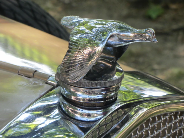 the front end of a shiny chrome vintage car